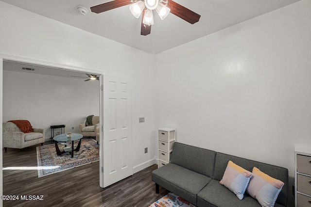 living room with ceiling fan and dark hardwood / wood-style flooring