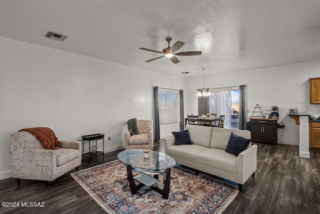 living room featuring dark hardwood / wood-style flooring and ceiling fan with notable chandelier