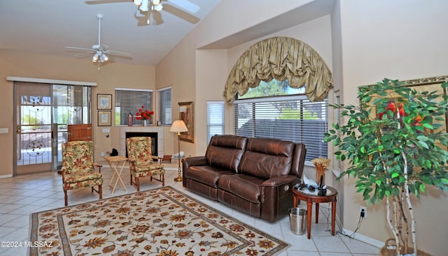 living room featuring ceiling fan, light tile patterned floors, and high vaulted ceiling