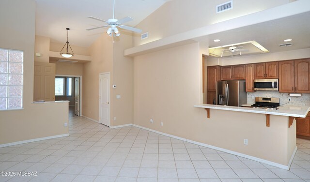 living room with ceiling fan with notable chandelier, light tile patterned flooring, and a fireplace