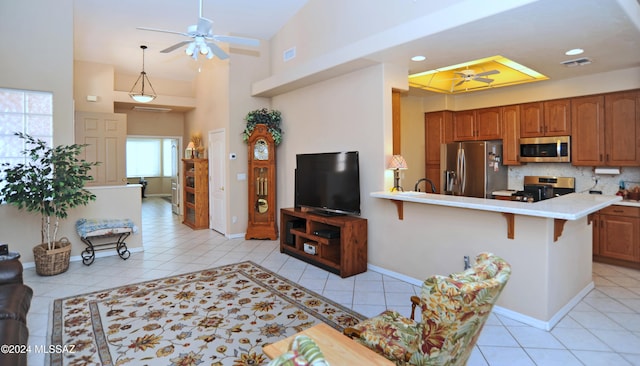 tiled living room with high vaulted ceiling and ceiling fan