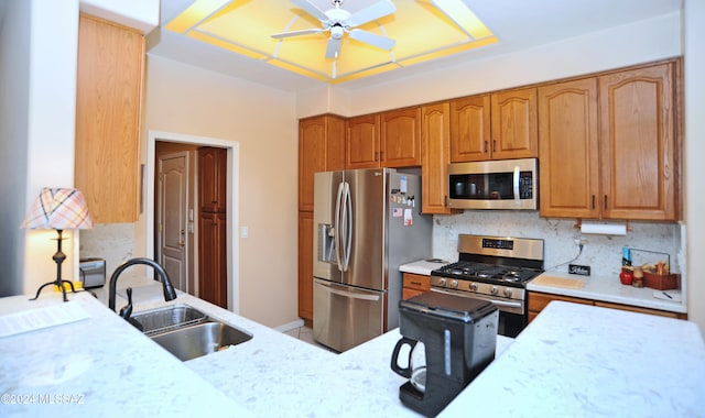 kitchen featuring backsplash, ceiling fan, sink, and appliances with stainless steel finishes