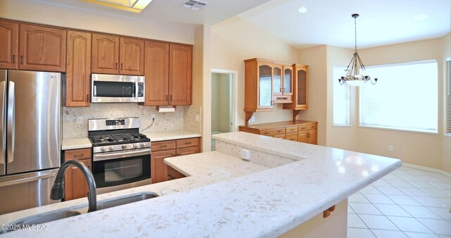 kitchen featuring stainless steel appliances, ceiling fan, sink, light tile patterned floors, and separate washer and dryer