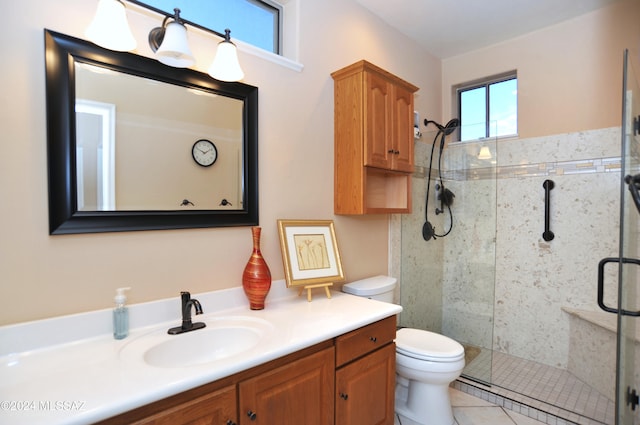 bathroom featuring tile patterned floors, vanity, toilet, and an enclosed shower