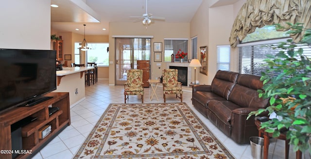 living room with light tile patterned floors and ceiling fan with notable chandelier