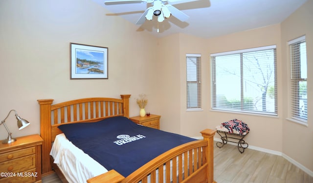 bedroom with multiple windows, ceiling fan, and light hardwood / wood-style floors