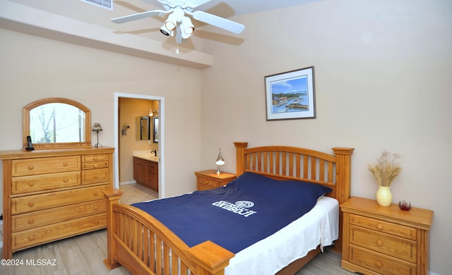 bedroom with ensuite bathroom, ceiling fan, and light hardwood / wood-style floors