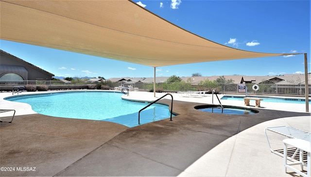 view of swimming pool with a community hot tub and a patio