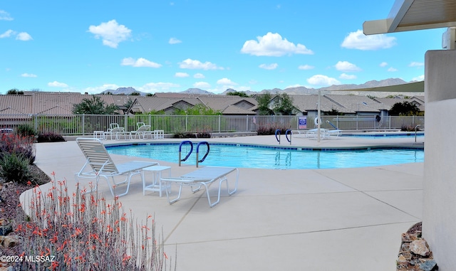 view of swimming pool featuring a mountain view and a patio area