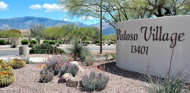 community / neighborhood sign with a mountain view