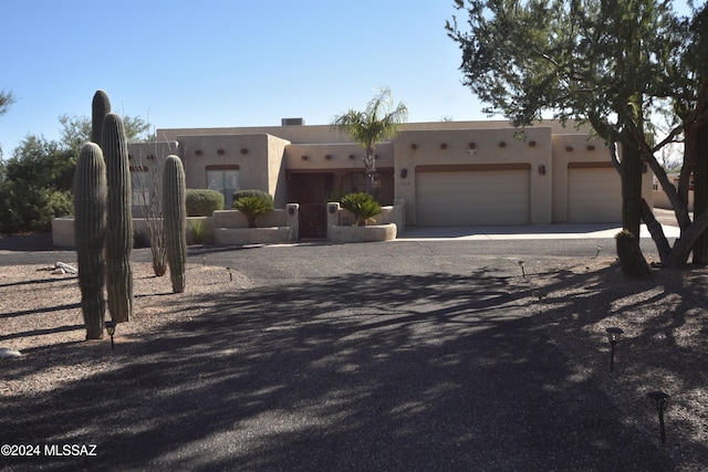 southwest-style home featuring a garage