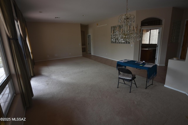 dining room featuring baseboards, carpet flooring, and a chandelier