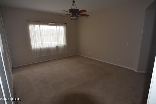 carpeted empty room featuring ceiling fan