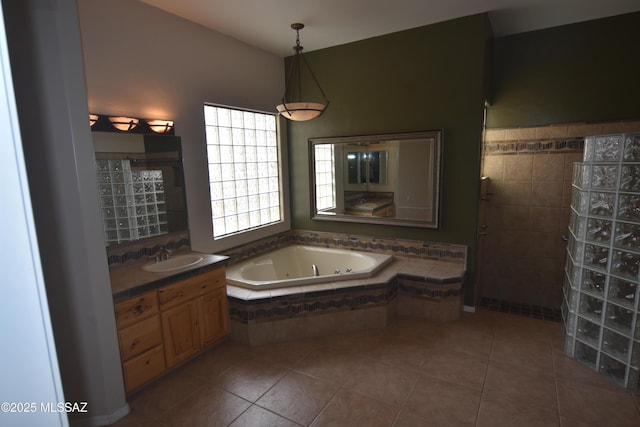 full bathroom with a whirlpool tub, tile patterned flooring, and vanity