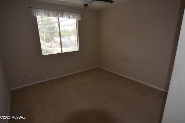 unfurnished room featuring baseboards, carpet flooring, and a ceiling fan