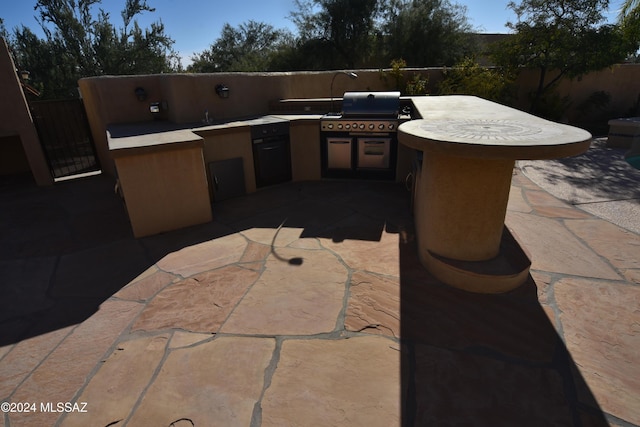 view of patio / terrace featuring a grill and exterior kitchen