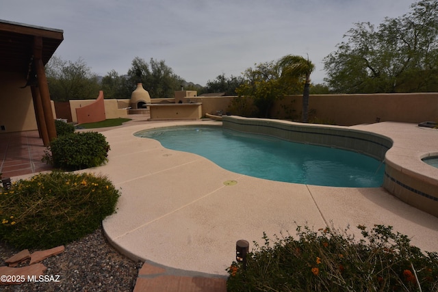 view of pool featuring a fenced backyard, a fenced in pool, an in ground hot tub, and a patio area