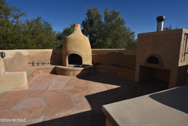 view of patio featuring exterior fireplace