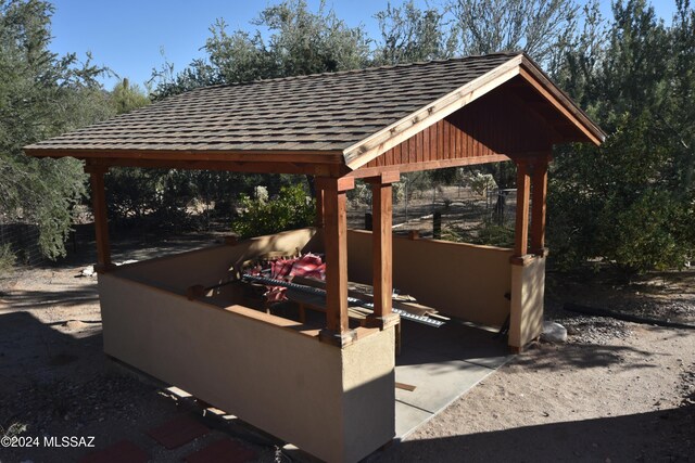 view of patio with area for grilling and a grill