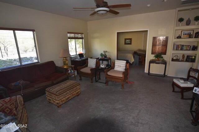 living area with carpet flooring, a ceiling fan, and visible vents