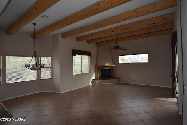 unfurnished living room featuring beamed ceiling, ceiling fan, a healthy amount of sunlight, and a fireplace