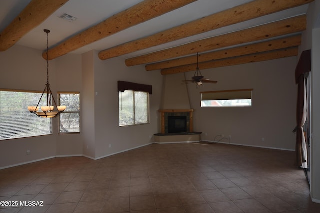 unfurnished living room featuring baseboards, ceiling fan, a fireplace with raised hearth, and beam ceiling