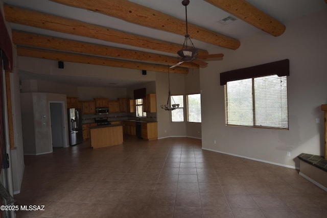 unfurnished living room with light tile patterned floors, beamed ceiling, and ceiling fan