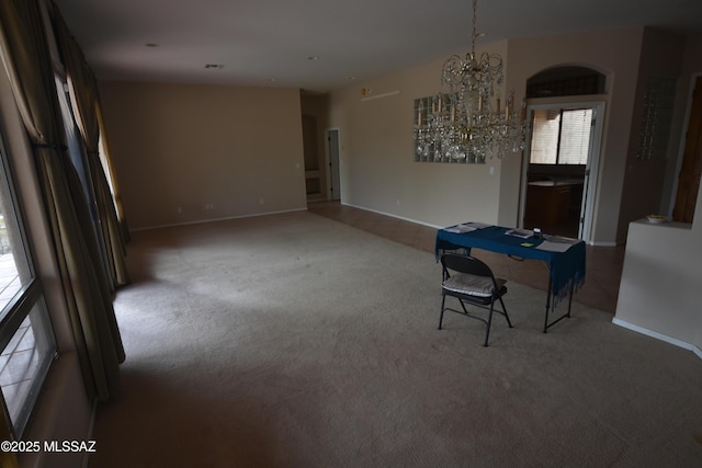 dining space featuring carpet and a chandelier