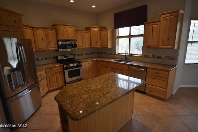 kitchen with light tile patterned flooring, decorative backsplash, stainless steel appliances, a sink, and stone counters