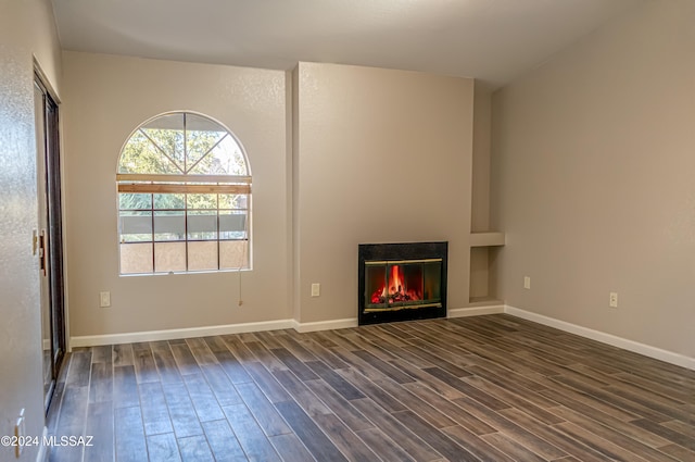 unfurnished living room with dark wood-type flooring