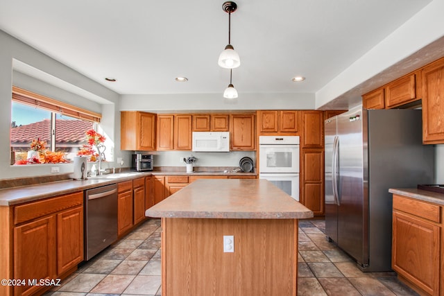 kitchen featuring pendant lighting, a center island, sink, and appliances with stainless steel finishes