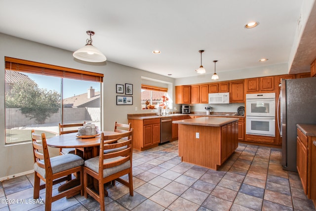 kitchen featuring a kitchen island, hanging light fixtures, and appliances with stainless steel finishes