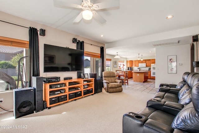 carpeted living room featuring ceiling fan