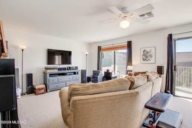 carpeted living room with ceiling fan