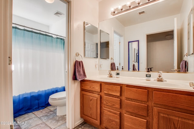 full bathroom featuring shower / bathtub combination with curtain, vanity, and toilet