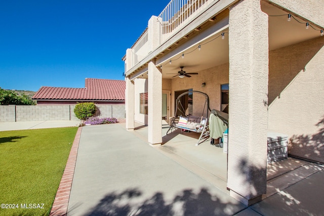 view of patio / terrace with ceiling fan and a balcony