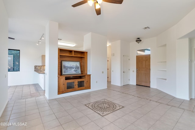 unfurnished living room featuring ceiling fan and light tile patterned floors