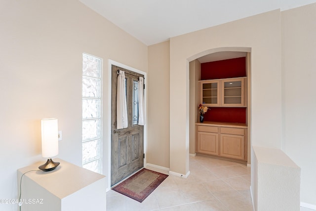 foyer with a healthy amount of sunlight and light tile patterned floors