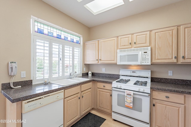 kitchen with white appliances, sink, and light brown cabinetry