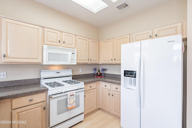 kitchen with light brown cabinets, white appliances, and light wood-type flooring