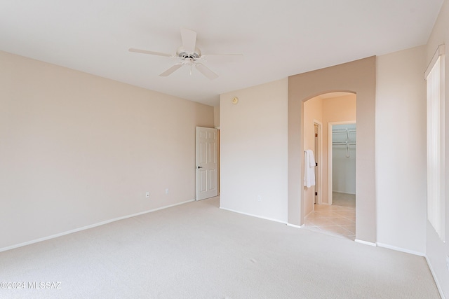 empty room featuring light colored carpet and ceiling fan