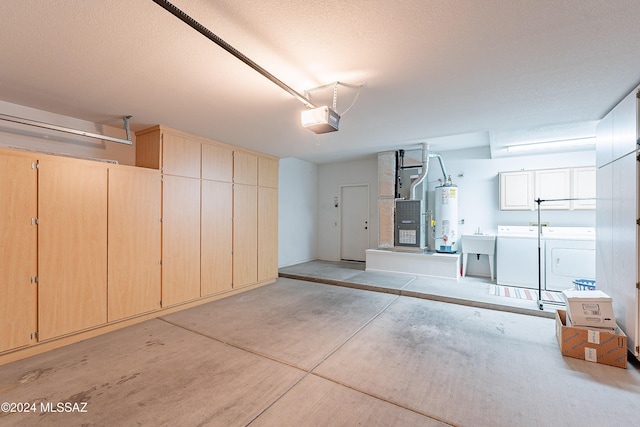 garage featuring gas water heater, separate washer and dryer, sink, and a garage door opener