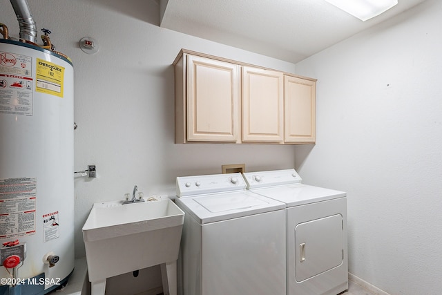 laundry room featuring washer and clothes dryer, cabinets, gas water heater, and sink