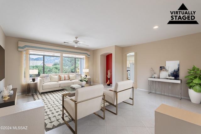 living room with light tile patterned floors and ceiling fan