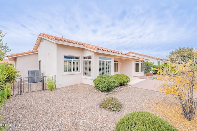 rear view of property featuring a patio area and central air condition unit