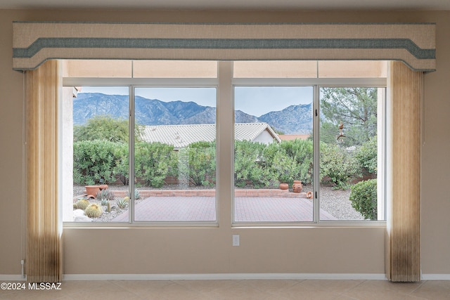 doorway to outside featuring a mountain view and tile patterned flooring