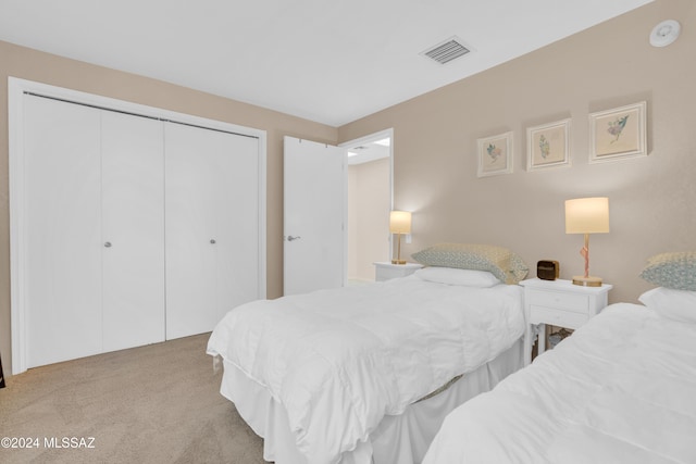 carpeted bedroom with a closet