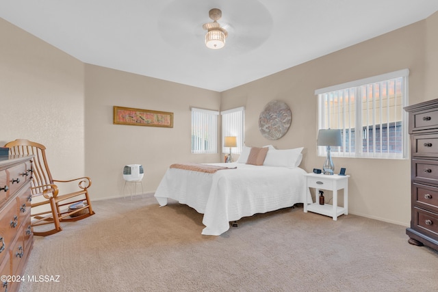 bedroom featuring light colored carpet and ceiling fan