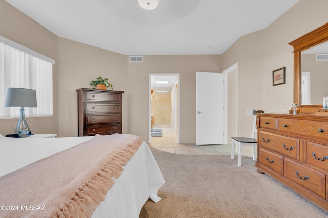 carpeted bedroom with ensuite bath