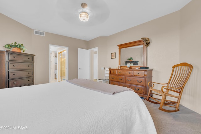 bedroom featuring carpet flooring and connected bathroom